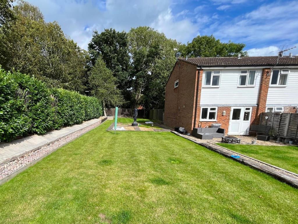 Lot: 127 - LAND WITH PLANNING FOR TWO 2/3 SEMI-DETACHED HOUSES - View of Land from Parking Area - Library Photograph